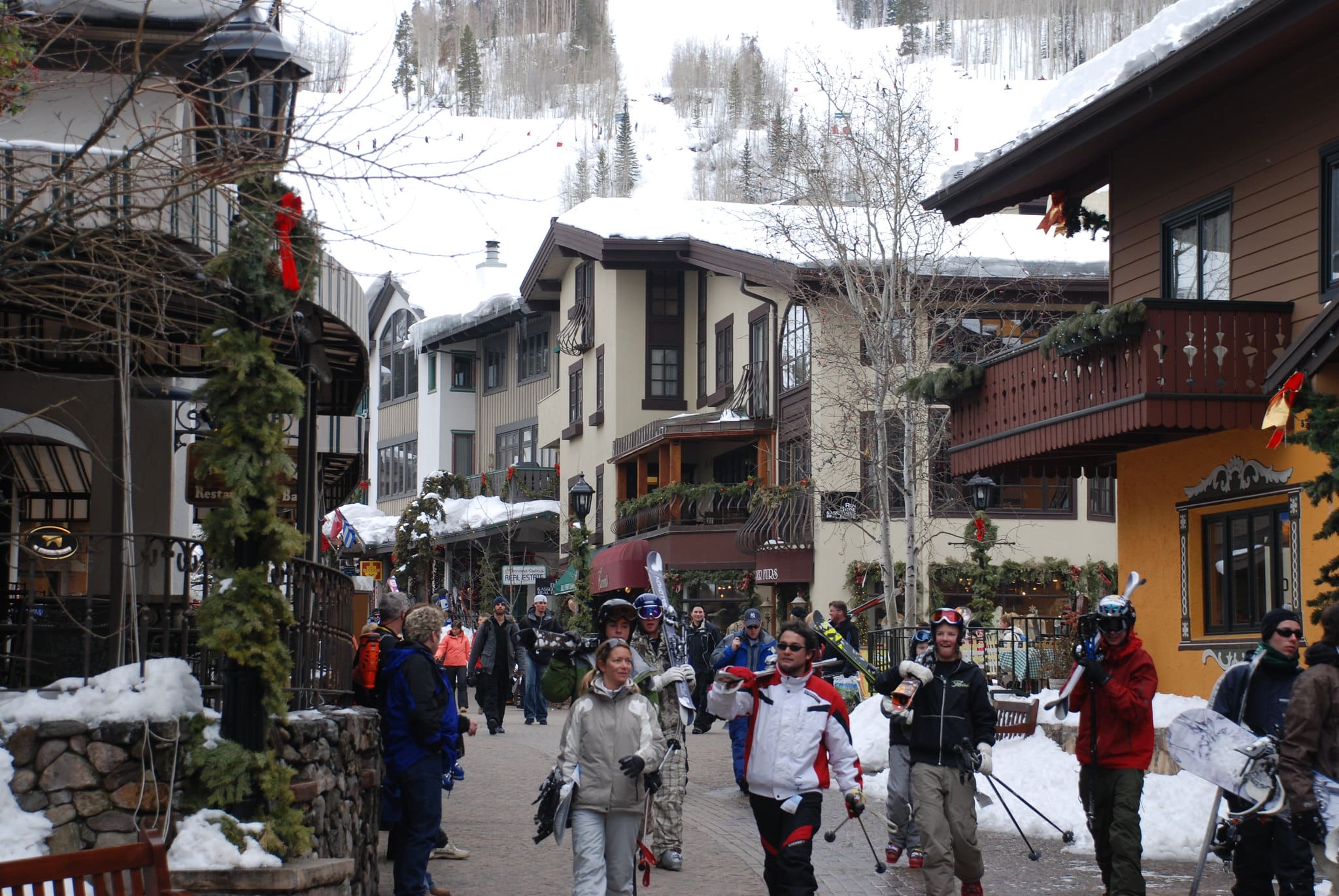 Austrian-inspired buildings lined pedestrian walkway filled with skiiers in Vail