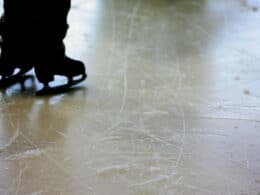 Image of a persons skates on an ice rink