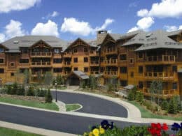 Exterior of Mountain Thunder Lodge, a wooden 4 story building with a semi-circle driveway in the front.