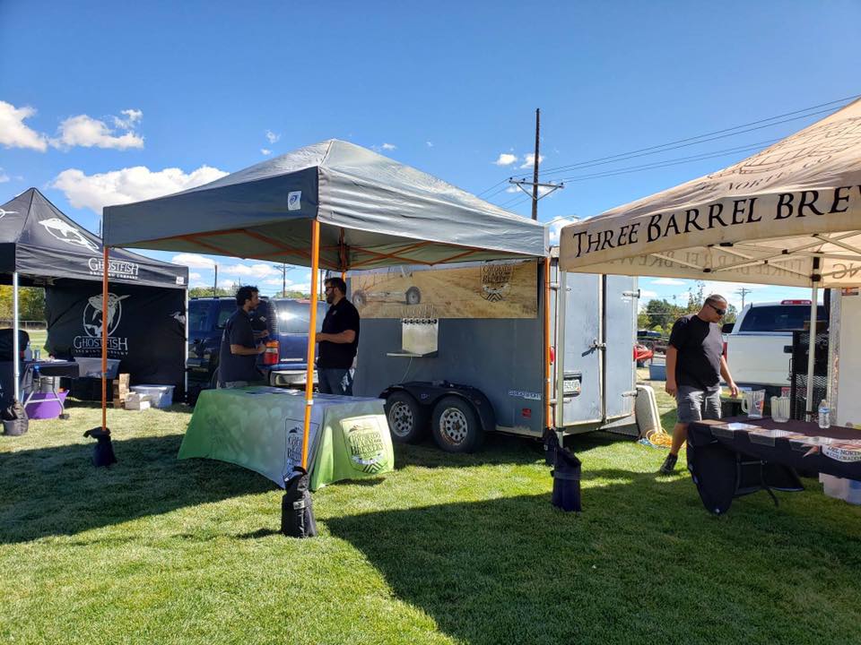 Two beer vendor tents setting up before guests arrive to the Oktobrufest in Alamosa.