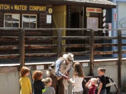 Image of a actor in the Pioneer Town Museum in Cedaredge teaching kids