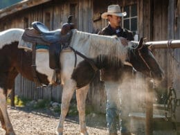 Image of a cowboy and his horse at the Rawah Guest Ranch in Colorado