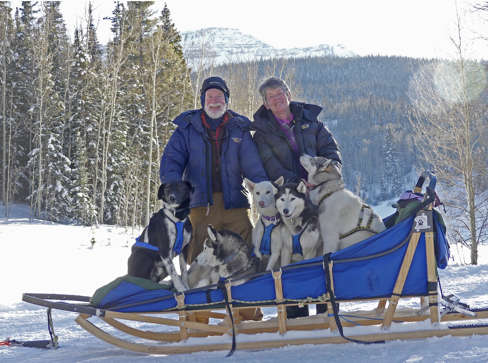 Family poses for photo with Snow Buddy Dog Sledding Colorado